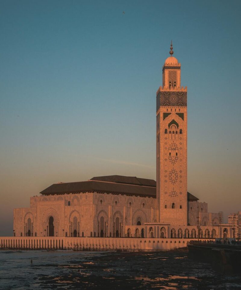 Stunning view of Hassan II Mosque against the sunset sky in Casablanca, Morocco.